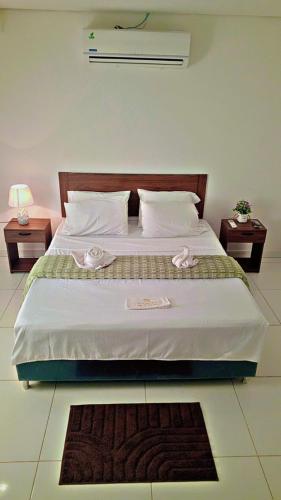 a bedroom with a large bed with two night stands at Hospedaje Alexa in Asunción