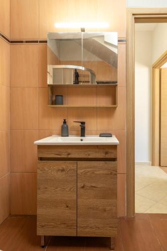 a bathroom with a sink and a mirror at Blue Skala - Indigo Apartment I in Skala