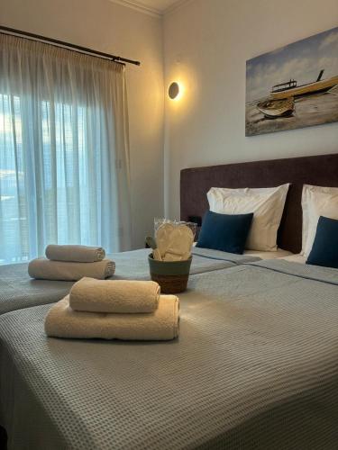 a bedroom with two beds with towels on a bed at Thanos ,Rooms and Apartments in Ouranoupoli