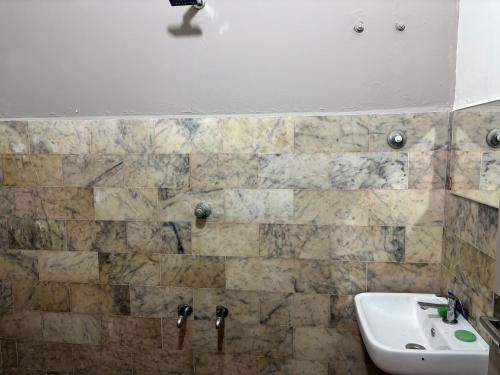 a bathroom with a sink and a white sink at Oceanbliss Villa in Pallipuram