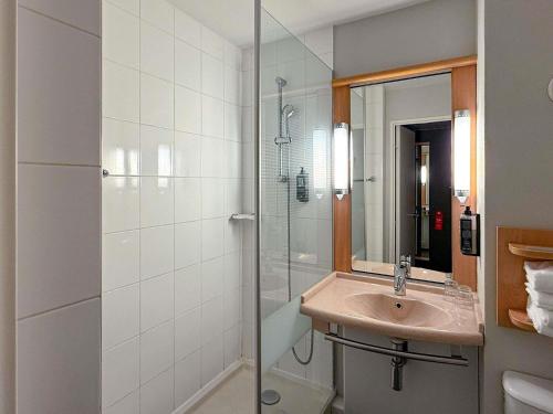 a bathroom with a sink and a shower at ibis Rennes Cesson in Cesson-Sévigné