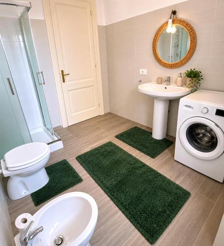 a bathroom with a sink toilet and a washing machine at Alba Mediterranea in Reggio di Calabria