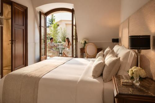 a bedroom with a large white bed and a table at Miravida Soho Hotel & Wine Bar in Buenos Aires