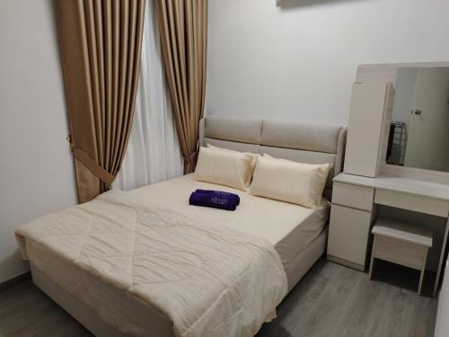 a bedroom with a bed and a vanity and a mirror at Sky13 Homestay in Kota Bharu