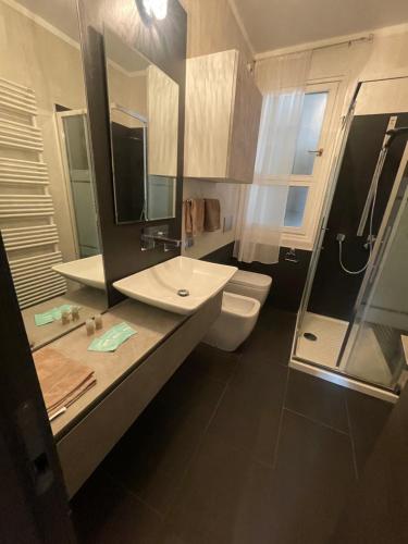 a bathroom with a sink and a toilet and a shower at Casa Estense in Lido degli Estensi