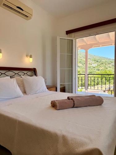 a bedroom with a bed with a towel on it at Xenia Apartments in Vasiliki
