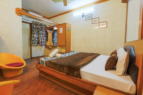a bedroom with a large bed in a room at Hotel Shrimmaya, Ujjain in Ujjain