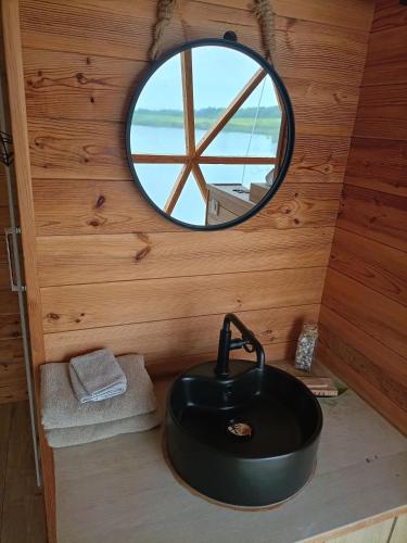 a bathroom with a black sink and a mirror at Les Gîtes De Robin'son in Foulcrey