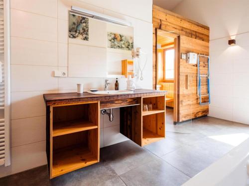 a bathroom with a sink and a wooden counter at Grasine 58 in Lake Pressegg