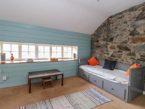 a room with a bed and a brick wall at Culearn Mill in Lochearnhead