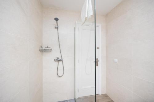 a shower with a glass door in a bathroom at Villa Trepuco Uno in Punta Prima