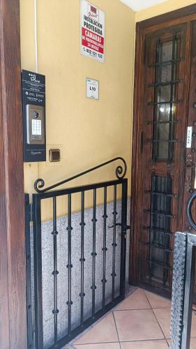 a gate in front of a building with signs on the wall at Hostal Maria Ronda in Madrid