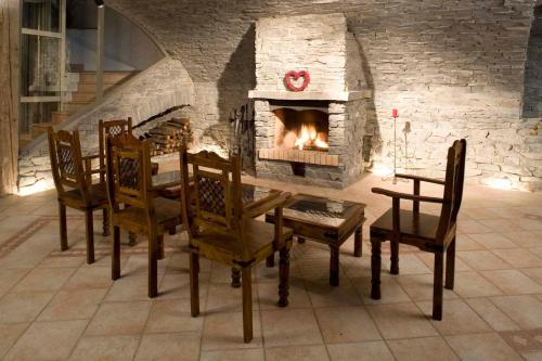 a dining room with a table and a fireplace at Penzion U Veterána in Slatinice