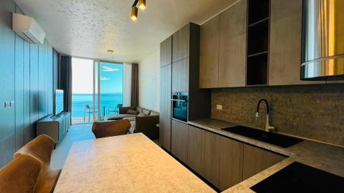 a kitchen with a table and a view of the ocean at TIS, Green Coast in Palasë