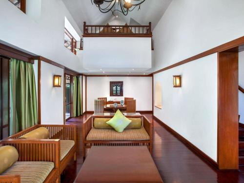 a living room with chairs and a table at Novotel Bogor Golf Resort & Convention Center in Bogor