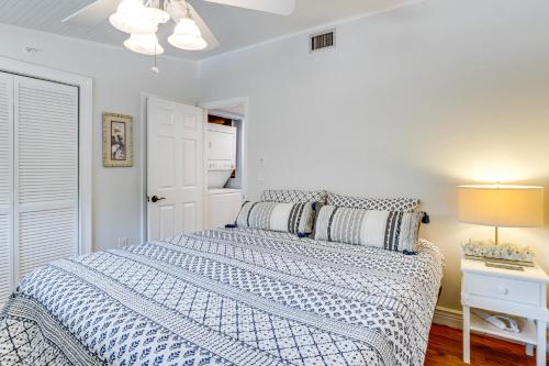 a bedroom with a bed with a blue and white comforter at Pool Access! Private Island Condo in Placida in Placida