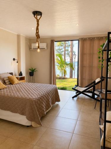 a bedroom with a bed and a large window at Casa Ypá in Puerto Libertad