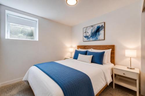 a bedroom with a large bed with blue pillows at Amazing 2BR condo with private terrace presented by TripMontreal II in Montreal