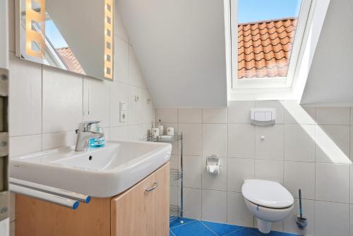 a bathroom with a sink and a toilet at Friesenperle in Greetsiel