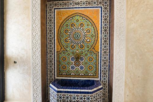 a mosaic tile on a wall in a room at Tamraght Ocean View in Tamraght Ouzdar