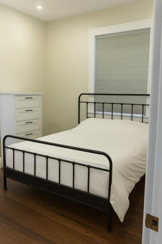 a bedroom with a bed and a dresser at The Signature Stay in Clifton