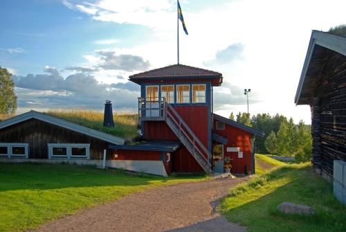 a red building with a staircase on the side of it at Dala Wärdshus in Rättvik
