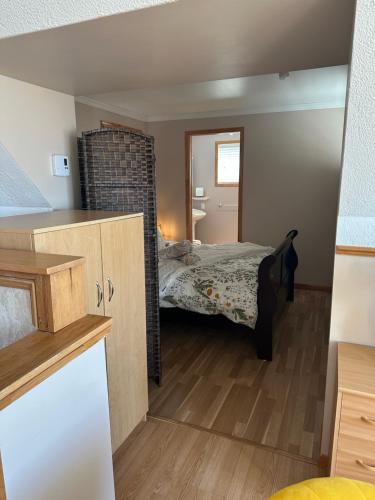 a small bedroom with a bed in a room at Loft de la mer in Sainte-Flavie