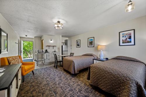 a hotel room with two beds and a kitchen at Cocusa Motel in Burlington