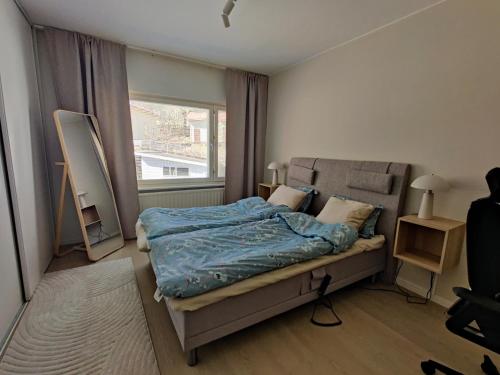 a bedroom with a bed and a large window at Room Sonaatti in Savonlinna