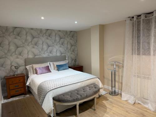 a bedroom with a bed with a large headboard at La CASA ROJA SOLARES in Solares