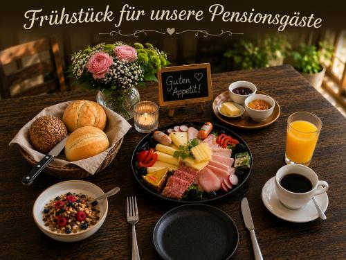 a table with a tray of breakfast foods and coffee at Pension und Berggasthaus Am Knochen in Geyer