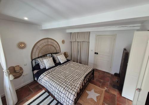 a bedroom with a large bed with pillows on it at Le petit Riyade in Cambayrac