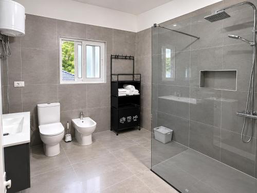 a bathroom with a shower and a toilet and a sink at Nova Rooms Velipojë in Velipojë
