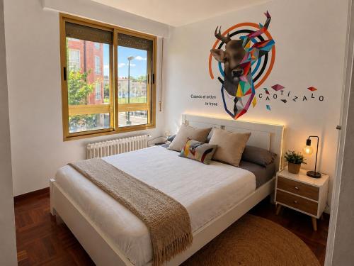 a bedroom with a bed with a antelope head on the wall at La Casa de los Inventos in Burgos