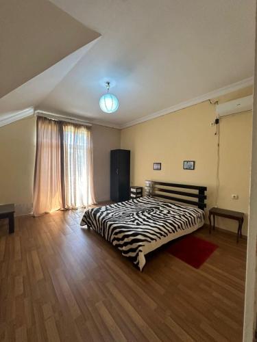 a bedroom with a large bed in a room at Дом для отпуска в Гонио in Gonio