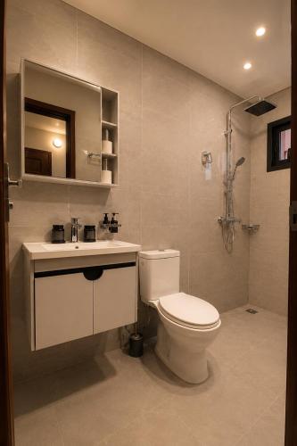 a bathroom with a toilet and a sink at Djess service in Abidjan
