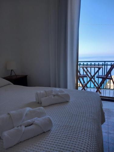 a bedroom with a bed with towels on it at Casa Bettina in Pizzo