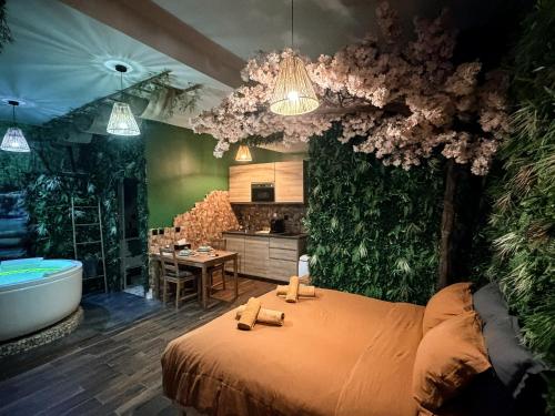 a bedroom with a tub and a bed and a bathroom at JUNGLE SUITE - Jacuzzi - Centre - Clim by Narbana in Narbonne