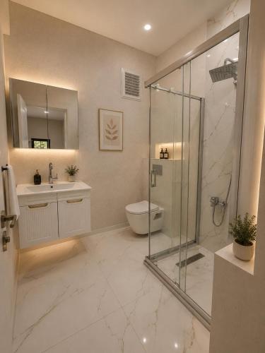 a bathroom with a shower and a toilet and a sink at Casa Florya Suites in Istanbul