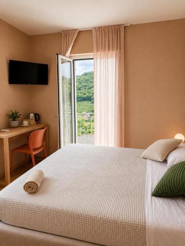a bedroom with a large bed and a window at Agriturismo Terra Madre in Rapallo
