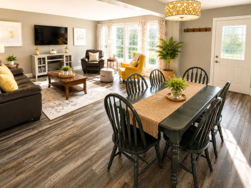 a living room with a dining room table and chairs at Downtown Picton Retreat - Near Sandbanks and Wineries in Picton