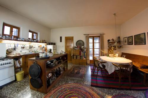 a large kitchen with a table and a counter top at Nightingale Cottage Pelion in Kalamaki