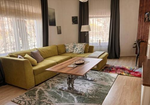 a living room with a couch and a coffee table at The Old Corner House in Velingrad