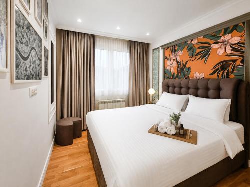 a bedroom with a large bed with a tray with teddy bears on it at Modern Harmony in Kolašin
