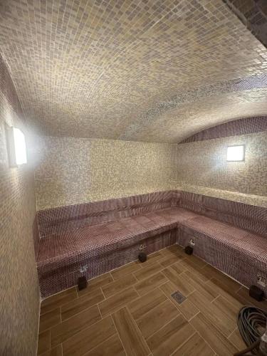 a waiting room with brown benches in a building at Eko park Jelići in Jelići