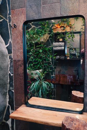 a mirror sitting on top of a wooden table at Hotel Ecopaisajes- Lake-Premier-Resort in Santa Rita