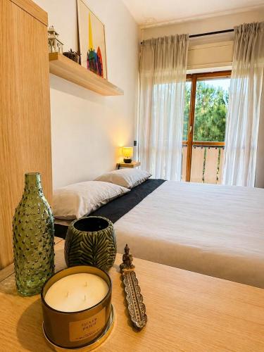 a bedroom with a bed and a table with a clock at Rome Home Cinecittà in Rome