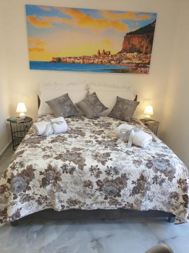 a bedroom with a large bed with a comforter at L'Approdo di Re Ruggero in Cefalù