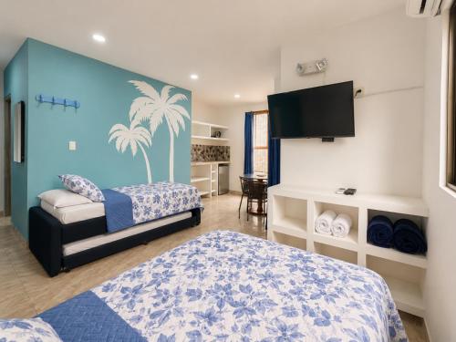 a bedroom with two beds and a flat screen tv at Avadia del Mar in Cartagena de Indias
