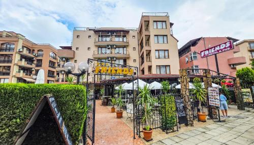 a group of buildings in a city with plants at Friends Family Hotel in Sunny Beach